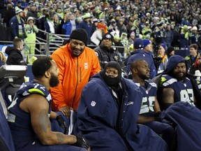 Former running back Marshawn Lynch of the Seattle Seahawks greets players during a game against the Carolina Panthers at CenturyLink Field on December 4, 2016.