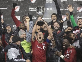 Toronto FC's Michael Bradley lifts the Eastern Conference Trophy after his team defeated the Montreal Impact during overtime MLS eastern conference playoff soccer final action in Toronto on Wednesday, November 30, 2016.THE CANADIAN PRESS/Chris Young ORG XMIT: CHY106