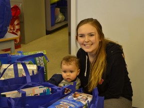Raven Conlinn and baby Kellan get an early start on Christmas when London Drugs delivered hundreds of gifts to her Coquitlam high school.