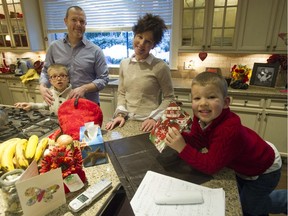 Erica and Harley Harris with their sons Hugh (red sweater), 6, and Hudson (white sweater), 9, at their North Vancouver. Erica has undergone several life-saving operations including bone marrow and lung transplants, and credits blood donors with saving her life.
