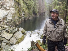 Shaun Hollingsworth, president of the Seymour Salmonid Society, watches water run through the rock slide that's blocking the Seymour River in North Vancouver on Nov. 30. Richard Lam/PNG