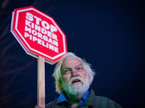 Paul George holds a sign during a protest against the Kinder Morgan Trans Mountain Pipeline expansion project, in Vancouver, B.C., on Tuesday November 29, 2016.