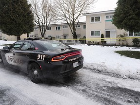 A Vancouver Police car sits outside an apartment block in the 2200 block of Hermon Dr. after a targeted shooting sent one person to hospital with serious injuries in Vancouver, December 21, 2016.