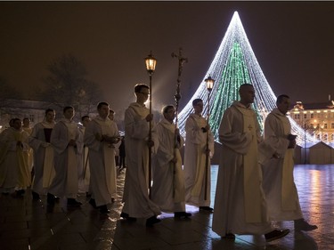 Priests and clergy process to attend the Christmas celebration midnight Mass at the Cathedral-Basilical in Vilnius, Lithuania, Saturday, Dec. 24, 2016. Over 80 percent of Lithuanians are Christians who celebrate the festival of Christmas on Dec. 25.