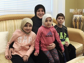 Eman Al-Atar with her children, L-R Batoul, Zainab and Jaafar (last name: Rojeab) at home in Queensborough, BC., December 22, 2016.