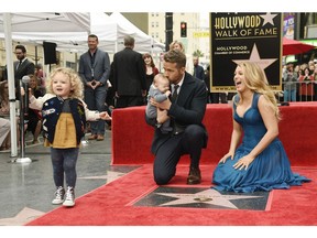 Ryan Reynolds' daughter James, left, steals the microphone as Reynolds poses with his wife, actress Blake Lively, and their youngest daughter during a ceremony to award him a star on the Hollywood Walk of Fame on Thursday, Dec. 15, 2016, in Los Angeles