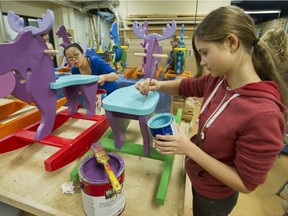 Volunteers put the finishing touches on wooden ride 'em toys at the wood shop at Fraser Heights Secondary school in Surrey, BC Wednesday, December 8, 2016. The toys will be distributed through the Surrey Christmas Bureau.