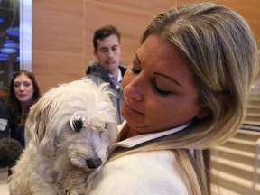 Terra McCabe from Vancouver is reunited with her dog Daisy at Winnipeg James Armstrong Richardson International Airport on Fri., Dec. 16, 2016.