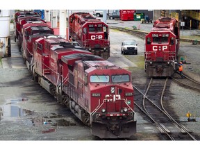 A Canadian Pacific Rail maintenance worker climbs onto a locomotive at the company's Port Coquitlam yard east of Vancouver. The provincial minister responsible for TransLink has echoed Metro Vancouver mayors’ call for an end to freight-related delays on the West Coast Express.