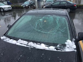 A vehicle damaged by falling snow bombs on the Port Mann Bridge on Monday.