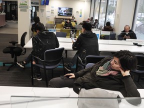 Builders and the general public wait for hours in the Permit and Planning department of City Hall in Vancouver.