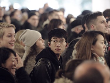 Commuters wait on packed platforms for the Evergreen Line train on its first rush day at Commercial Drive Station in Vancouver, BC., December 5, 2016.