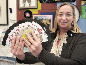 Mount Pleasant Elementary principal Jann Schmidt holds gift cards for the Adopt-A-School program.