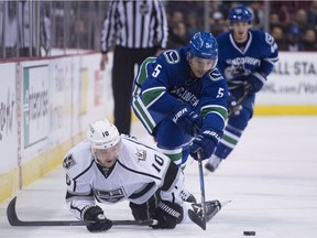 Vancouver Canucks defenceman Luca Sbisa (5) vies for control of the puck with Los Angeles Kings right wing Devin Setoguchi (10) during first period NHL action in Vancouver, B.C., Wednesday, December 28, 2016.