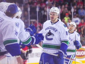 Nikita Tryamkin #88 of the Vancouver Canucks celebrates with his teammates after scoring against the Calgary Flames during an NHL game at Scotiabank Saddledome on December 23, 2016 in Calgary, Alberta, Canada.