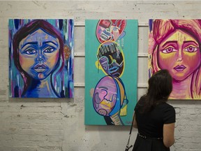 A woman looks at art, part of an anti-extremism campaign created by SFU criminology students, at The Hive Vancouver.