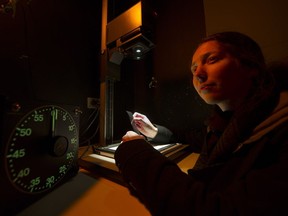August Bramhoff examines a 35mm negative under the light of an enlarger at the darkroom in the Dunbar Community Centre. The centre plans to close the darkroom this month.