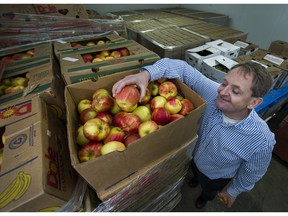 Aart Schuurman Hess, the CEO of the Greater Vancouver Food Bank Society, in the cold storage room with a box of apples on Dec. 21, 2016. Cash donations are used to buy fresh fruits and vegetables.