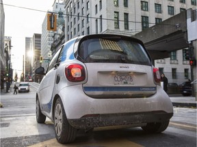 A car2go vehicle exits a parkade Thursday at Cordova and Granville in downtown Vancouver.