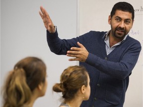 Masud Azar, a family and youth outreach worker, teaches a class to refugees at SUCCESS. More than three-quarters of the Syrian refugees in B.C. have been able to access English classes, but just 17 per cent have been able to find work in the year since they arrived, according to a report released Friday.