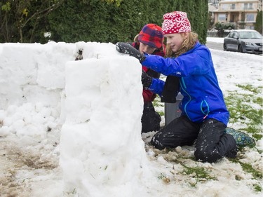 Children build a snow fort in Vancouver, BC, December, 5, 2016.
