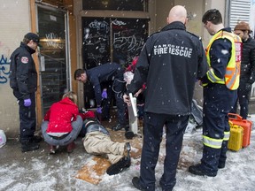 First responders attend to an unresponsive drug user in the Downtown Eastside on Dec. 9.