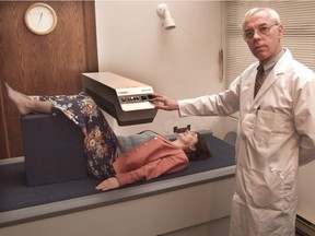 Dr. Myron MacDonald of West Vancouver is shown with an unidentified patient in a 1996 file photo.
