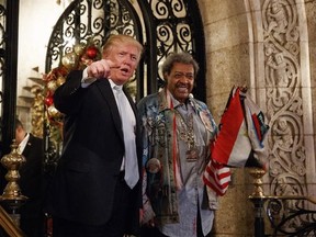 FILE - In this Wednesday, Dec. 28, 2016, file photo, President-elect Donald Trump, left, stands with boxing promoter Don King as he speaks to reporters at Mar-a-Lago, in Palm Beach, Fla. Many of Trump‚Äôs cultural touchstones, which he‚Äôd frequently namedrop at campaign rallies and on Twitter, including Don King, were at their peak in the 1980s, the decade that Trump‚Äôs celebrity in New York rose, Trump Tower was built, ‚ÄúThe Art of the Deal‚Äù was published and he first flirted with running