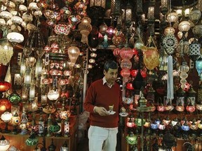 In this Thursday, Jan. 5, 2017 photo, a shop owner holds cups of tea outside his shop in Istanbul&#039;s Grand Bazaar, one of Istanbul&#039;s main tourist attractions. Turkey&#039;s economy is suffering in the face of a string of extremist attacks _ including the nightclub massacre of New Year‚Äôs revelers, most of them foreigners _ and uncertainty following the failed coup in July against President Recep Tayyip Erdogan that saw more than 270 people killed. (AP Photo/ Emrah Gurel)