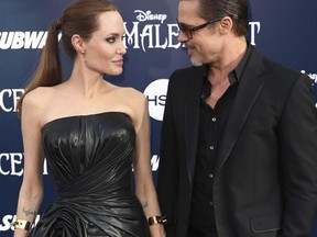 FILE - In this May 28, 2014 file photo, Angelina Jolie and Brad Pitt arrive at the world premiere of &ampquot;Maleficent&ampquot; in Los Angeles. Angelina Jolie Pitt and Brad Pitt have reached an agreement to handle their divorce in a private forum and will work together to reunify their family, the actors announced in a joint statement Monday, Jan. 9, 2017. (Photo by Matt Sayles/Invision/AP, File)