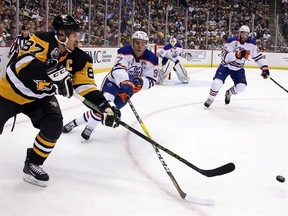 Pittsburgh Penguins&#039; Sidney Crosby (87) gets off a pass in front of Edmonton Oilers&#039; Connor McDavid (97) during the second period of an NHL hockey game in Pittsburgh, Tuesday, Nov. 8, 2016. While McDavid has indeed given Crosby a run for his money as the best player in hockey, the Penguins captain still reigns supreme at the midway point of the 2016-17 season. THE CANADIAN PRESS/AP, Gene J. Puskar