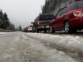 FILE - In this Dec. 10, 2015 file photo, vehicles along eastbound Interstate 90 heading up Snoqualmie Pass are stopped in snow and slush during a road closure in Washington state. The recent deaths of two Washington State University students driving back to campus in Pullman, Wash., after winter break have revived concerns about the safety of roadways leading to the rural college town. (AP Photo/Ted S. Warren, file)