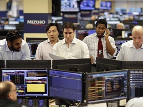 In this Jan. 12, 2017 photo, traders work on the Mizuho Americas trading floor in New York. World stocks were mostly lower Thursday ahead of comments from the European Central Bank&#039;s president and after Federal Reserve chair Janet Yellen signaled more interest rate increases in the months to come. (AP Photo/Mark Lennihan)