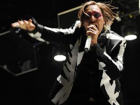 Win Butler of Arcade Fire performs during their headlining set on the third day of the 2014 Coachella Music and Arts Festival in Indio, Calif. in this April 13, 2014 file photo. THE CANADIAN PRESS/AP- Photo by Chris Pizzello/Invision/AP, File