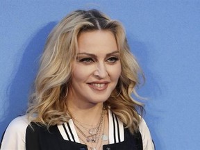 FILE - In this Sept. 15, 2016 file photo, Madonna poses for photographers upon arrival at the World premiere of the film &ampquot;The Beatles, Eight Days a Week&ampquot; in London. Madonna is trying to put a positive spin on President-elect Donald Trump&#039;s Friday, Jan. 20, 2017, inauguration. The superstar spoke at the Brooklyn Museum Thursday night, Jan. 19, with artist Marilyn Minter about art in a time of protest, among other things. (AP Photo/Kirsty Wigglesworth, File)