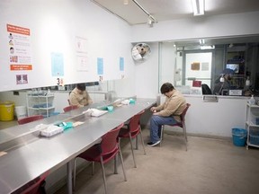 Justin Hall injects heroin at the Crosstown Clinic in downtown Vancouver, Thursday, Jan. 12, 2017. About 94 participants come into Crosstown two or three times a day, rotating through a schedule starting at 7:30 a.m. and ending at 10:05 p.m. at the only clinic in North America that provides supervised medicinal heroin, or diacetylmorphine. THE CANADIAN PRESS/Jonathan Hayward