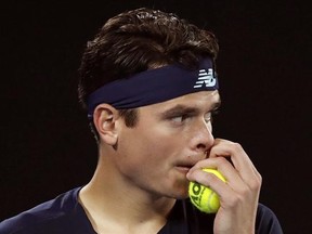 Canada&#039;s Milos Raonic grabs a ball while playing Spain&#039;s Rafael Nadal- during their quarterfinal at the Australian Open tennis championships in Melbourne, Australia, Wednesday, Jan. 25, 2017. Tennis star Milos Raonic has withdrawn from Canada&#039;s Davis Cup World Group tie against Britain after a nagging adductor injury flared up during his recent Australian Open run. THE CANADIAN PRESS/AP, Kin Cheung