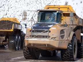 40-tonne trucks haul material at the Site C dam construction site.