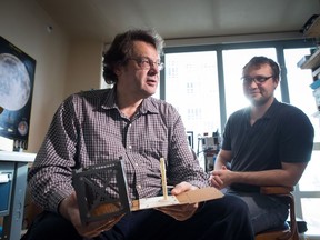 Alex Dobrianski, left, sitting for a photograph with his son Sergei Dobrianski, holds a model of the structure of their proposed entry in the Google Lunar X competition, in Vancouver, B.C., on Wednesday January 18, 2017. Over the past five years, the father-and-son team has been developing the technology to send a 3D printer to the moon that can extract and use the various fine-grained metals coating the lunar surface to one day build everything from satellites to computer processors.