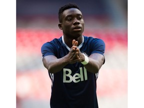 Vancouver Whitecaps' Alphonso Davies stretches while warming up with his teammates before a CONCACAF Champions League soccer match against Sporting Kansas City in Vancouver, B.C., on Tuesday August 23, 2016.