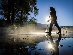 An employee washes away the remains of grape pressing at the Okanagan Valley's River Stone Estate Winery in Oliver, B.C., Thursday, Sept. 15, 2016.