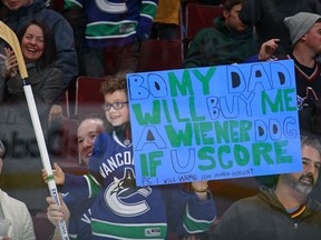 A young fan smiles after receiving a stick from Bo Horvat #53 of the Vancouver Canucks after Horvat scored during their NHL game against the Arizona Coyotes at Rogers Arena January 4, 2017 in Vancouver, British Columbia, Canada. Vancouver won 3-0.