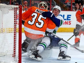 Bo Horvat gives a hug to Steve Mason upon crashing the Flyers' crease in 2015 in Philadelphia.