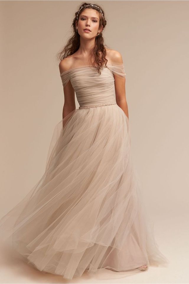 Delicate champagne tulle with off-the-shoulder details, a ruched bodice and voluminous skirt make this Ramona gown by Elaya Vaughn is a welcome departure from traditional gowns. BHLDN.com | $1,300