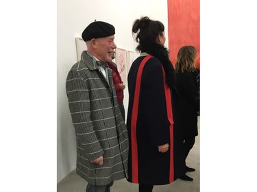 A dapper man in shades of grey and a red striped woman match the colours of the show.