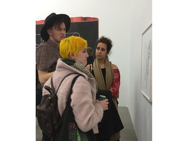 Neon yellow hair brightens a pale pink coat, while her friend wears her shirt off the shoulder.