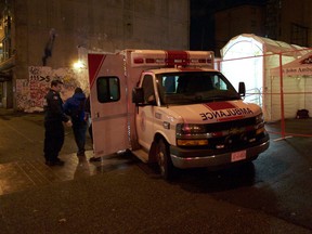 An ambulance delivers a patient to a mobile emergency facility in Vancouvers Downtown Eastside on December 22, 2016.