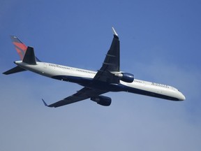 A Delta Air Lines Boeing 757 flies overhead in Seattle on Jan. 12.