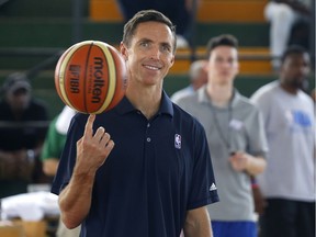 Former Los Angeles Lakers player Steve Nash spins a basketball at the start of a four-day training camp at a university in Havana in April 2015.