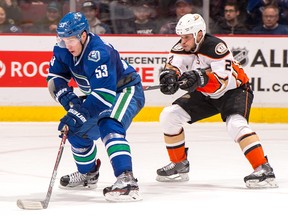 Kevin Bieksa of the Ducks tries to slow down the Canucks' Bo Horvat.